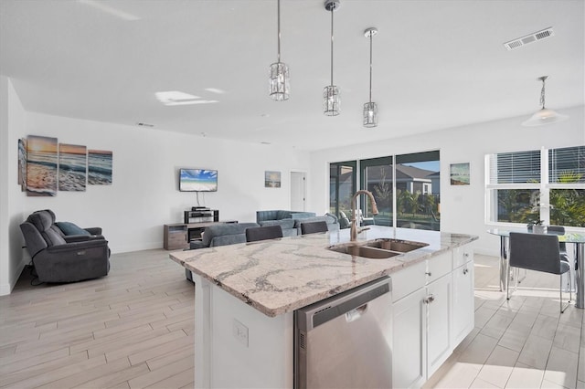 5415 Limelight Dr, Apollo Beach, FL 33572 - kitchen with dishwasher, a sink, open floor plan, hanging light fixtures, and baseboards