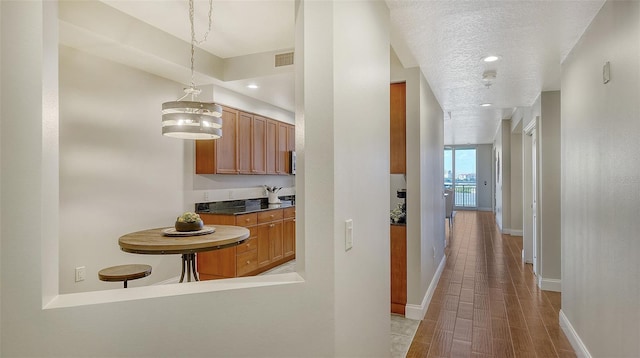 hall with a textured ceiling