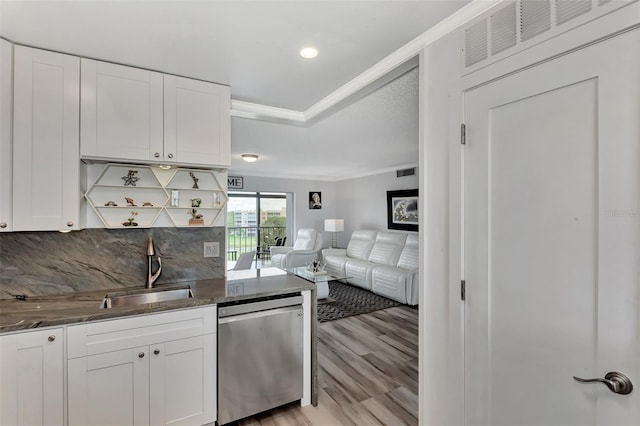 kitchen featuring white cabinets, dishwasher, ornamental molding, sink, and backsplash