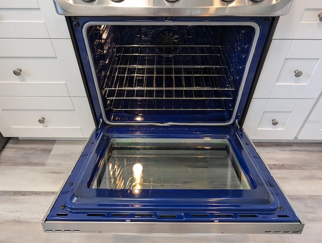 details featuring blue cabinets, white cabinets, and dishwasher