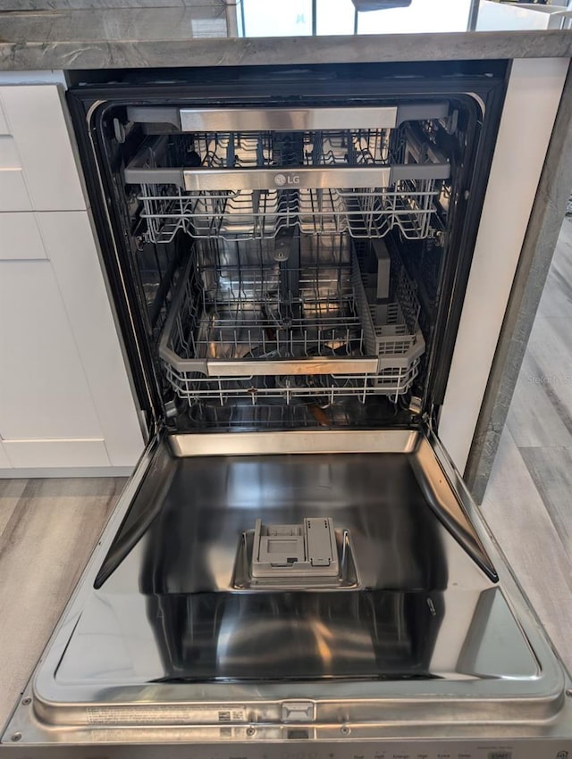 interior details featuring white cabinetry and dishwashing machine