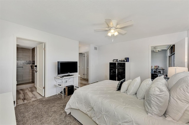 bedroom featuring ensuite bathroom, carpet flooring, and ceiling fan