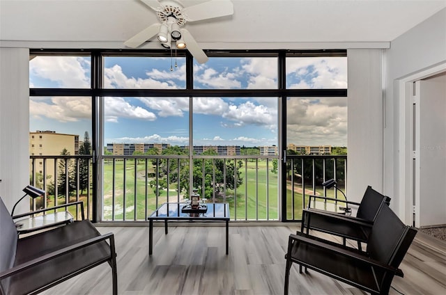 sunroom / solarium featuring ceiling fan and a wealth of natural light