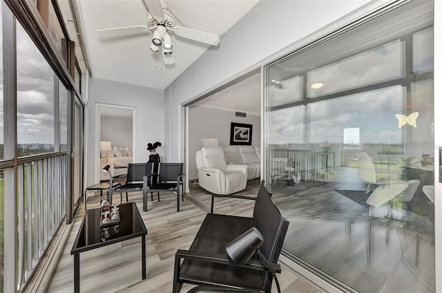 sunroom / solarium featuring ceiling fan