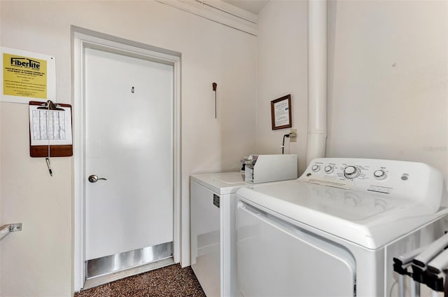 clothes washing area featuring separate washer and dryer