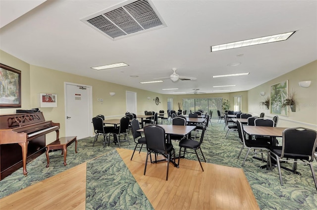 dining space featuring ceiling fan and hardwood / wood-style flooring