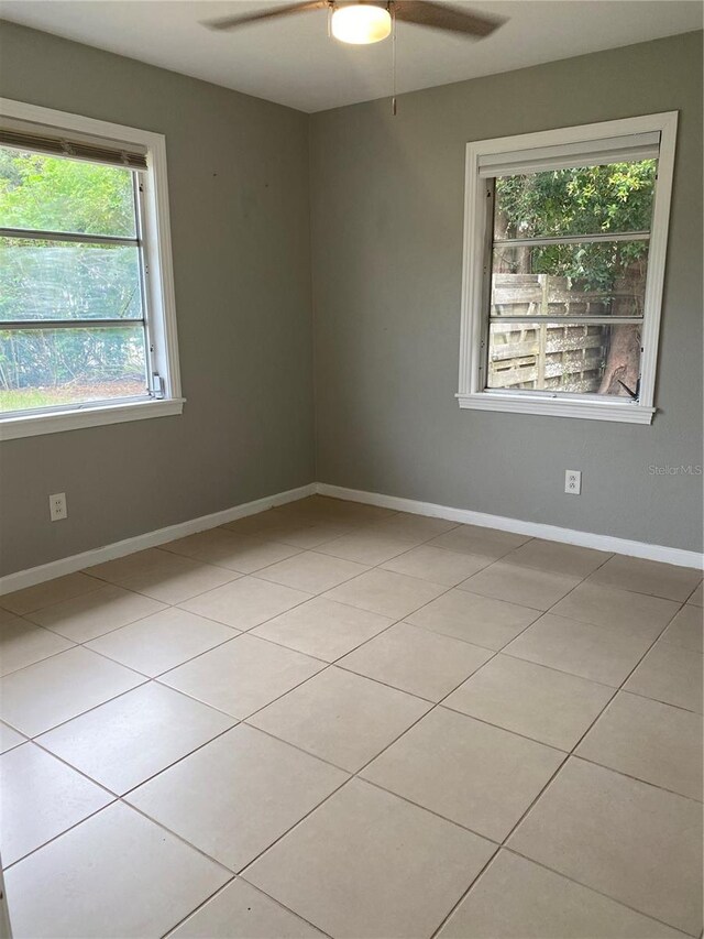 tiled empty room with ceiling fan