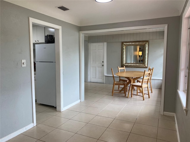 dining area featuring light tile patterned floors