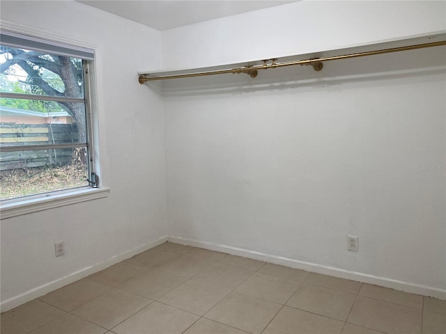 spacious closet with light tile patterned floors