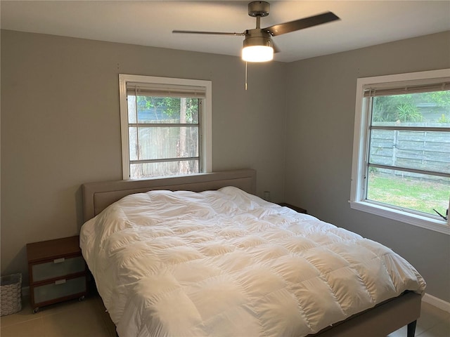 bedroom with multiple windows and ceiling fan