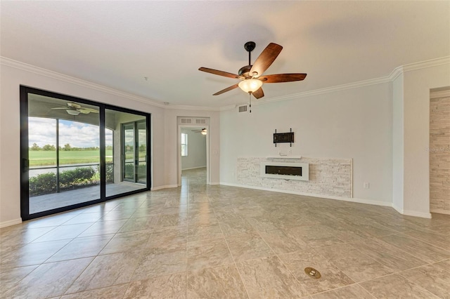 unfurnished living room featuring crown molding, ceiling fan, and a stone fireplace