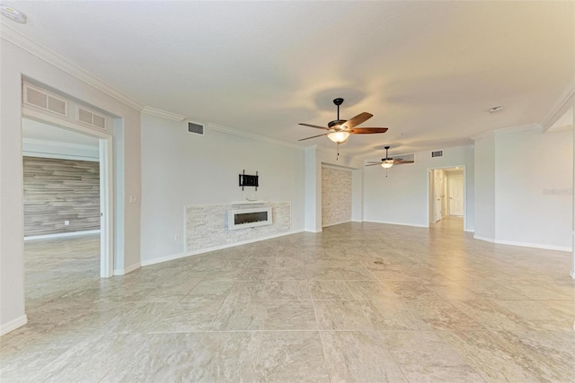 unfurnished living room with ceiling fan, a stone fireplace, and crown molding