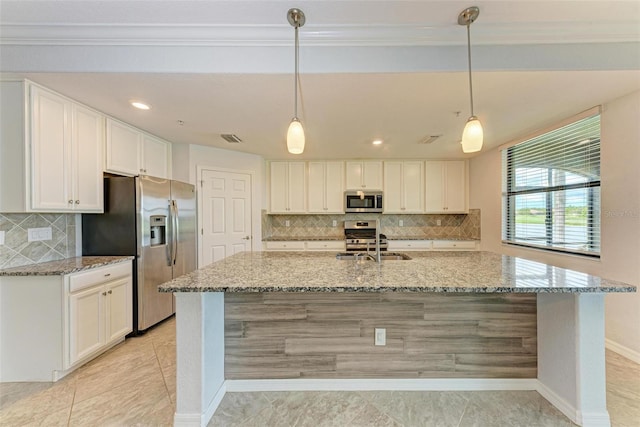 kitchen with stainless steel appliances, white cabinetry, and light stone countertops