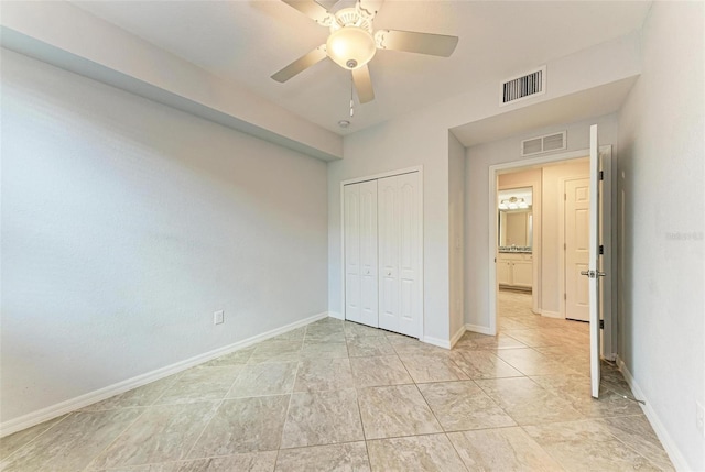 unfurnished bedroom with ceiling fan and a closet