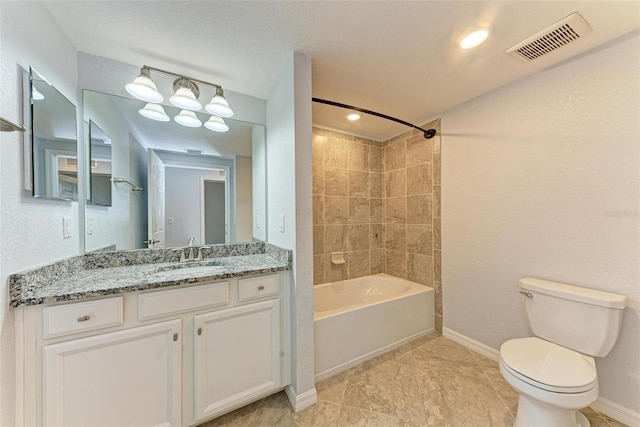 full bathroom with tiled shower / bath combo, vanity, and toilet