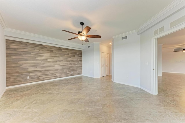 spare room with ceiling fan, wooden walls, and ornamental molding