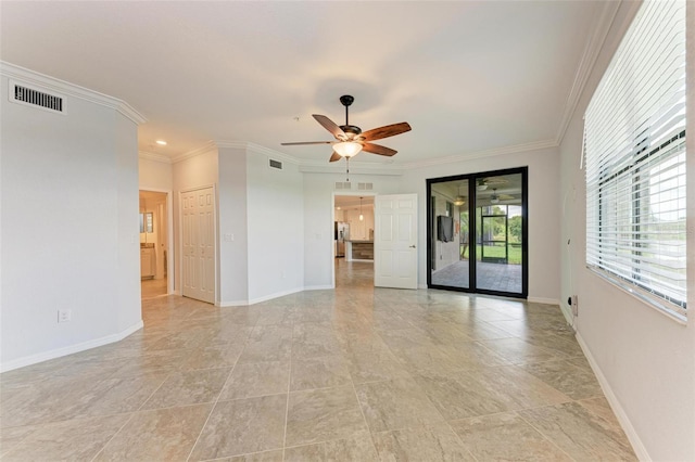 unfurnished room with ceiling fan and crown molding