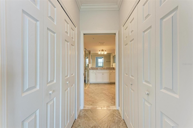 hallway with light tile patterned flooring and crown molding