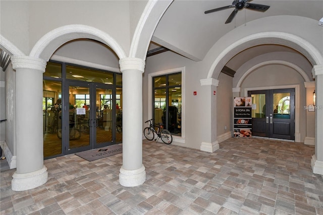 interior space featuring ceiling fan, decorative columns, and french doors