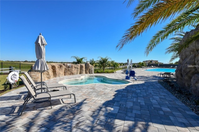 view of swimming pool featuring a patio area