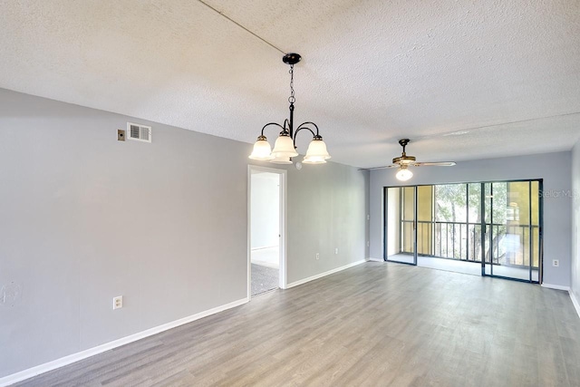 unfurnished room featuring hardwood / wood-style flooring, a textured ceiling, and ceiling fan with notable chandelier