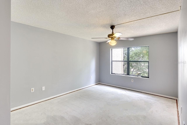 unfurnished room featuring ceiling fan and a textured ceiling