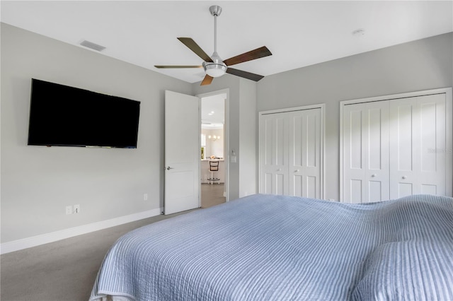 bedroom featuring multiple closets, carpet floors, and ceiling fan