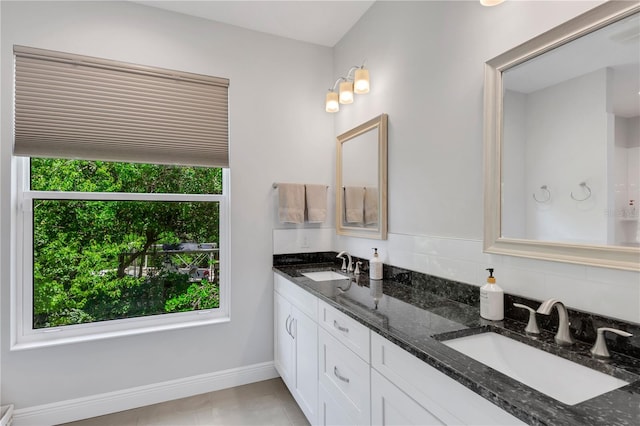 bathroom with tile patterned flooring and dual vanity