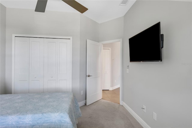 bedroom with light tile patterned flooring, a closet, and ceiling fan