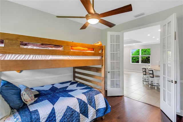 bedroom featuring french doors, hardwood / wood-style floors, and ceiling fan