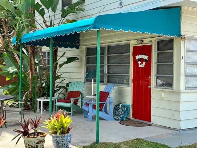 view of exterior entry featuring a patio