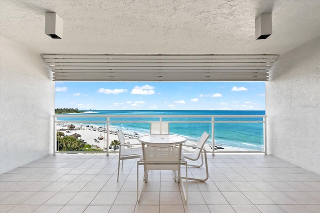 balcony with a view of the beach and a water view