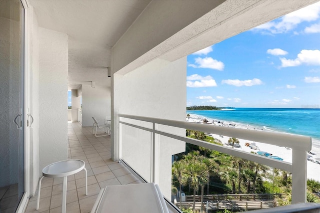 balcony with a beach view and a water view