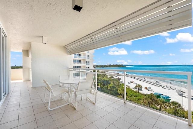 balcony with a view of the beach and a water view