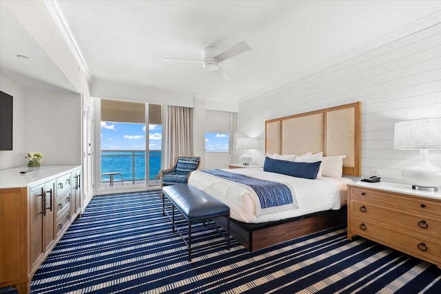 bedroom with access to exterior, dark carpet, ceiling fan, crown molding, and a water view