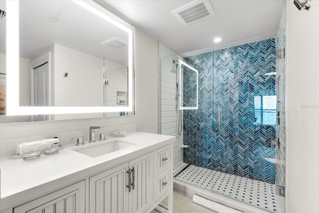 bathroom featuring vanity and an enclosed shower