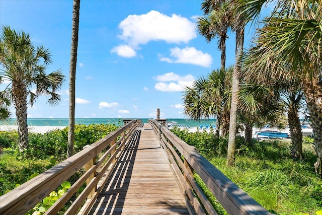 view of property's community featuring a water view and a beach view