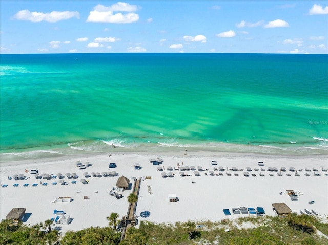 birds eye view of property with a water view and a view of the beach