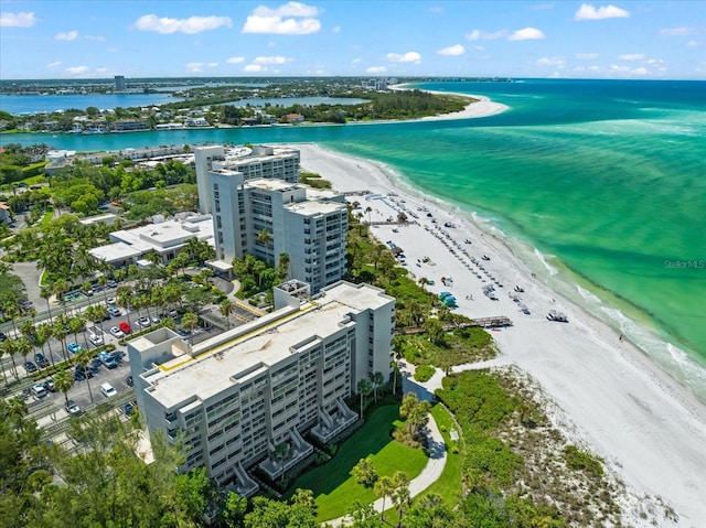 drone / aerial view featuring a water view and a beach view