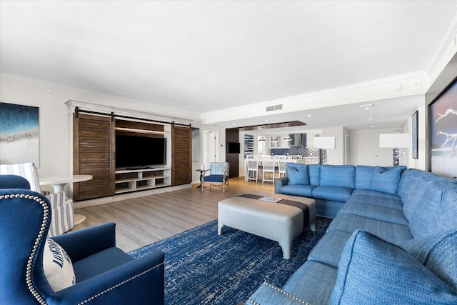 living room with ornamental molding and wood-type flooring