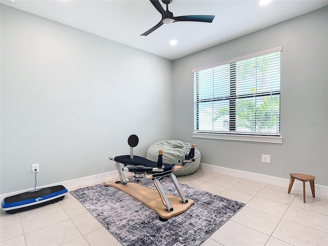 workout area featuring light tile patterned floors and ceiling fan