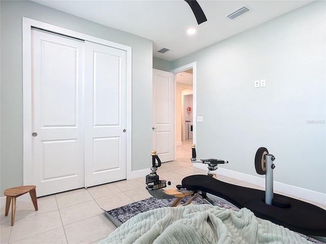 exercise room with light tile patterned floors