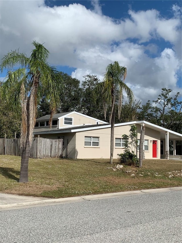 view of side of home featuring a yard