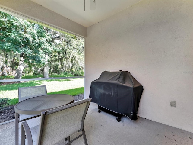 view of patio with ceiling fan and a grill