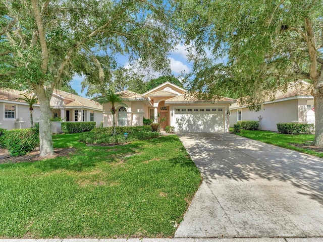 view of front of house with a front yard and a garage