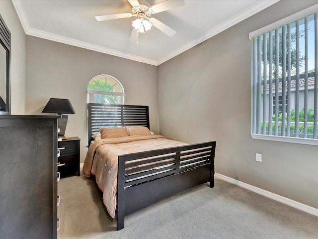 carpeted bedroom with ceiling fan and crown molding