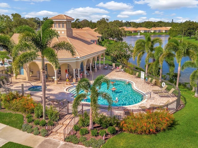 view of swimming pool featuring a water view and a patio area