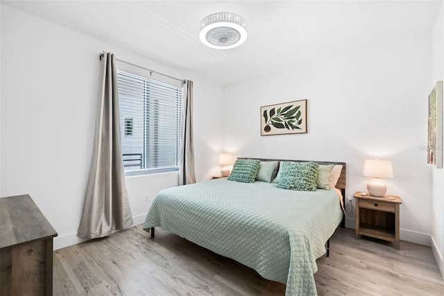 bedroom with wood finished floors and baseboards