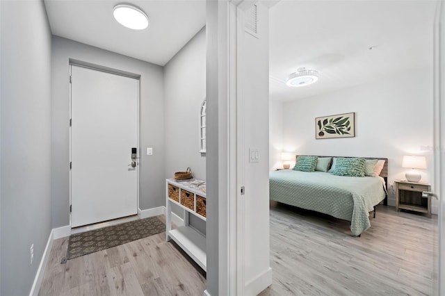 entryway with baseboards and light wood-style floors