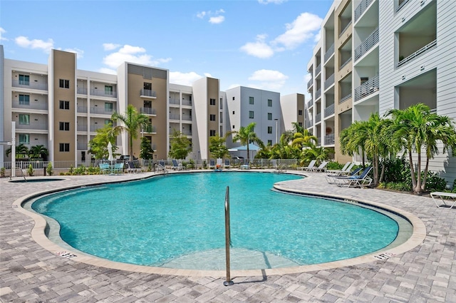 pool featuring a patio area and fence